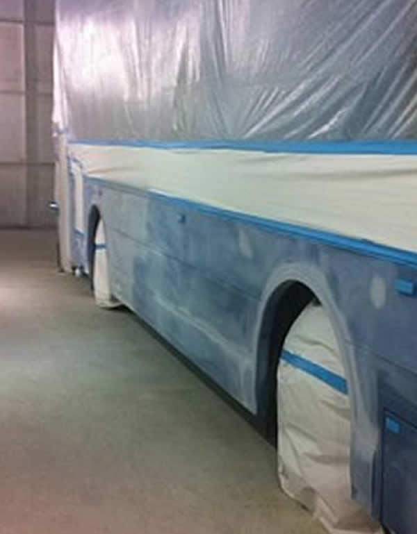Coach side panel prepared during panel repair